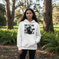 Latino teen girl in Golden Gate Park wearing white environmental protest hoodie