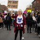 Older woman in white Still We Rise tank at women's protest