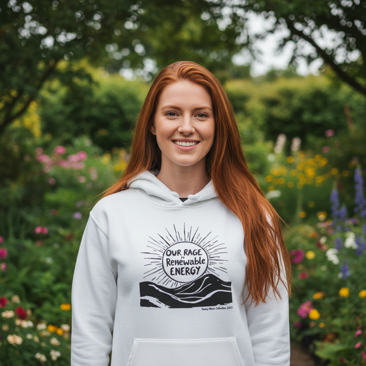 Red-haired woman with long hair in hoodie at garden