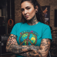 Tattoo-covered woman in Tropical Blue Peace Music Collective tee